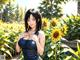 A woman standing in a field of sunflowers.